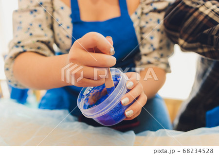 Ingredient for make home made Toy Called Slime, Teenager having fun and being creative homemade slime. Selective focus on Slime. 68234528
