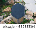Closeup black metal sign at green grass background, nameplate with a space for your text, copyspace, empty space for inscription 68235504