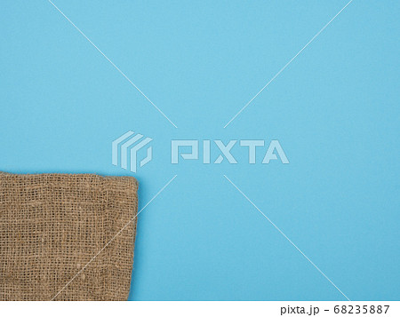 The texture of the burlap on a blue background. The texture of the burlap on a blue background. 68235887