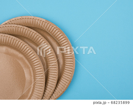 Cardboard plates on a blue background. The view 68235899