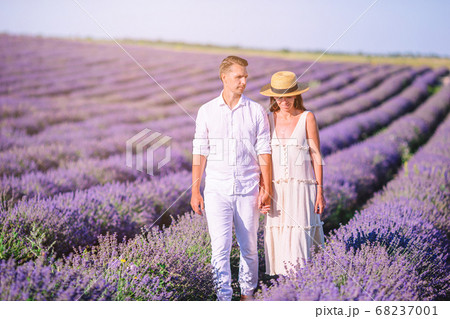 Family in lavender flowers field at sunset in white dress and hat Family in lavender flowers field at sunset in white dress and hat 68237001