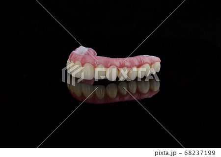 High-quality dental prosthesis made by dental technician, prosthesis with a pink gingiva to fix after implantation. 68237199