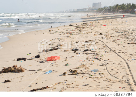 Beach of Da Nang City, Vietnam, after storm, covered with garbage. This is the South China Sea of the Pacific Ocean. Beach of Da Nang City, Vietnam, after storm, covered with garbage. This is the South China Sea of the Pacific Ocean. 68237794