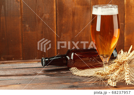 Glass beer on wood background. creative photo. Glass beer on wood background. creative photo. 68237957