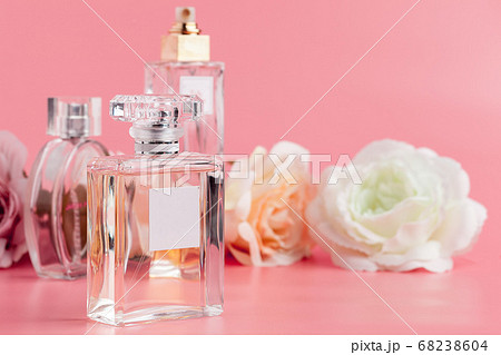 Perfume bottle with roses on pink fabric background 68238604
