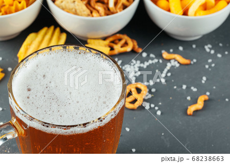 Lager beer and snacks on stone table. Cracker, chips side view. creative photo. 68238663