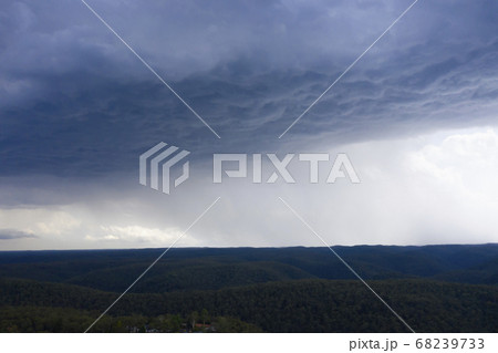 A severe thunderstorm and rain over a valley in The Blue Mountains in Australia A severe thunderstorm and rain over a valley in The Blue Mountains in Australia 68239733