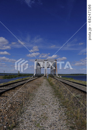 Distant twin railway bridge against sky 68247166