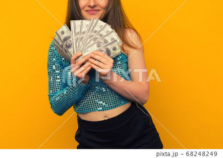 Joyful girl won the lottery and holds a fan of US 68248249