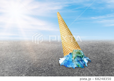 Global Warming and Pollution Concept : Ice cream planet earth melting on asphalt road with blue sky and sunlight in background.  68248350