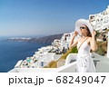 Europe Greece Santorini travel vacation woman on famous santorini Oia island travel destination. Happy young tourist woman. Summer wanderlust. 68249047