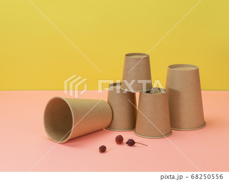 Disposable cups and berries of wild rose on yellow Disposable cups and berries of wild rose on yellow 68250556
