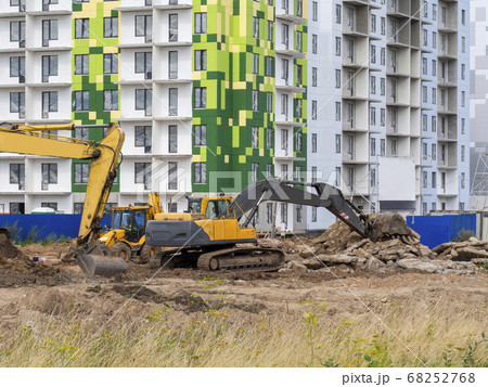 Excavator digs the ground for the foundation  68252768