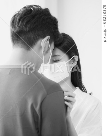 Young asian woman and man wearing Surgical mask at home in black and white 68253379