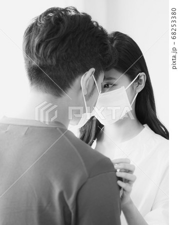 Young asian woman and man wearing Surgical mask at home in black and white 68253380