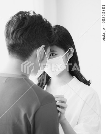 Young asian woman and man wearing Surgical mask at home in black and white 68253381