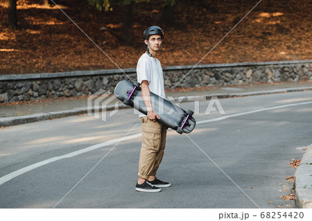 Portrait of a guy with a board in his hands. 68254420