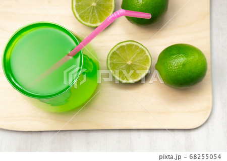 Lemonade glasses with lime, wooden Board on a black background. Refreshing summer drink - detox cocktail Lemonade glasses with lime, wooden Board on a black background. Refreshing summer drink - detox cocktail 68255054