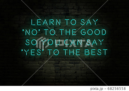 Wise quote. Neon inscription against brick wall 68256558