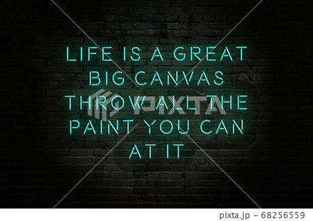 Wise quote. Neon inscription against brick wall 68256559