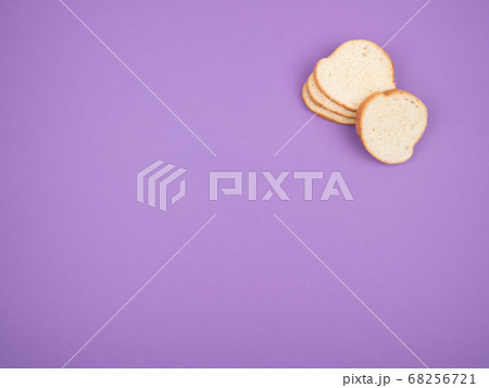 Sliced white bread on a purple background. 68256721