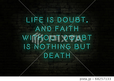 Wise quote. Neon inscription against brick wall Wise quote. Neon inscription against brick wall 68257133