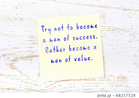 Yellow sticky note on wooden wall with wise quote 68257528