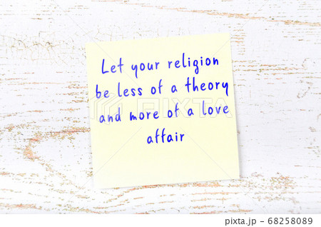 Yellow sticky note on wooden wall with wise quote 68258089