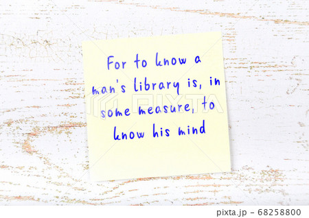 Yellow sticky note on wooden wall with wise quote 68258800