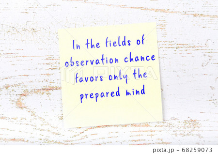 Yellow sticky note on wooden wall with wise quote 68259073