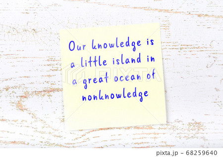Wise quote on sticky note on wooden wall Wise quote on sticky note on wooden wall 68259640