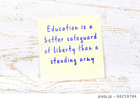 Yellow sticky note on wooden wall with wise quote Yellow sticky note on wooden wall with wise quote 68259784