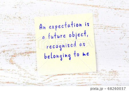 Wise quote on sticky note on wooden wall Wise quote on sticky note on wooden wall 68260037