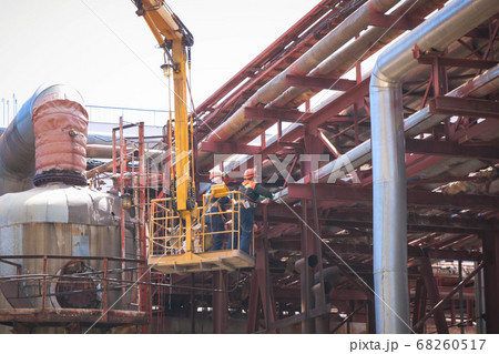 Workers repairmen fitter welders repair pipelines 68260517