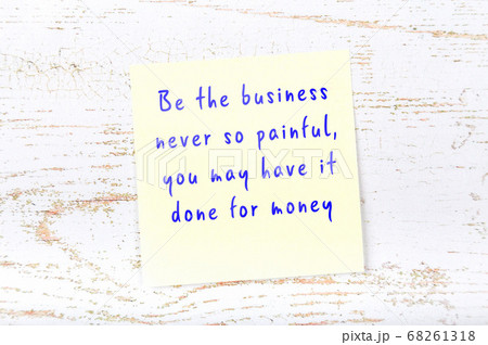 Yellow sticky note on wooden wall with wise quote 68261318
