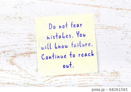 Wise quote on sticky note on wooden wall Wise quote on sticky note on wooden wall 68261565