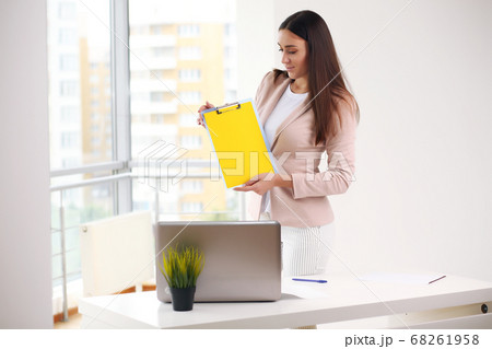 Young pretty business woman with notebook in the office 68261958