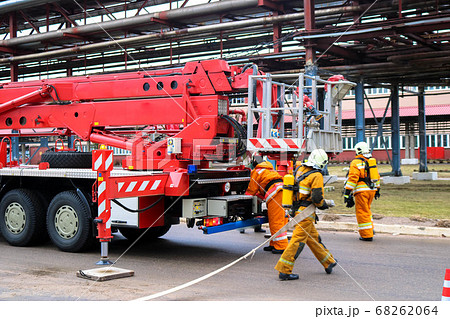 Firemen rescue workers in fireproof suits came Firemen rescue workers in fireproof suits came 68262064