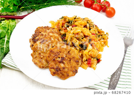Fritters meat with cabbage in plate on white board Fritters meat with cabbage in plate on white board 68267410