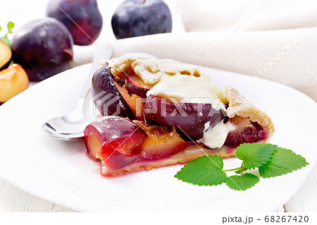 Galeta with plums in plate on light table 68267420