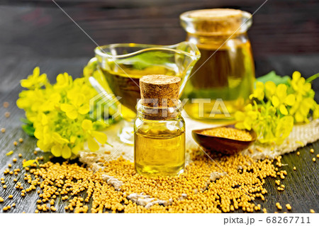 Oil mustard in two jars and gravy boat on board Oil mustard in two jars and gravy boat on board 68267711