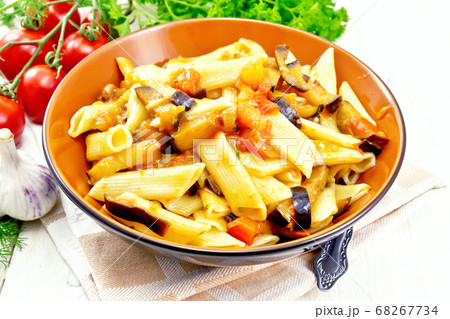 Pasta penne with eggplant and tomatoes on board Pasta penne with eggplant and tomatoes on board 68267734