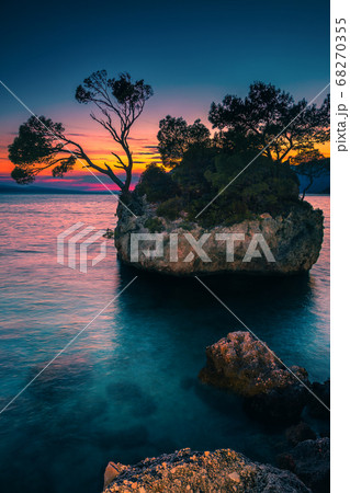 Small rocky island in the sea at sunset, Brela, Croatia Small rocky island in the sea at sunset, Brela, Croatia 68270355