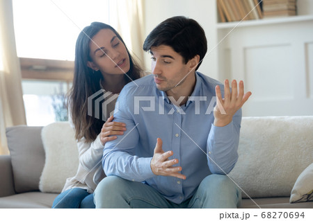 Loving young guilty woman trying making peace with angry guy. Loving young guilty woman trying making peace with angry guy. 68270694