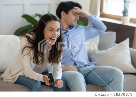 Couple disagree on channel choice or tv program. 68270879