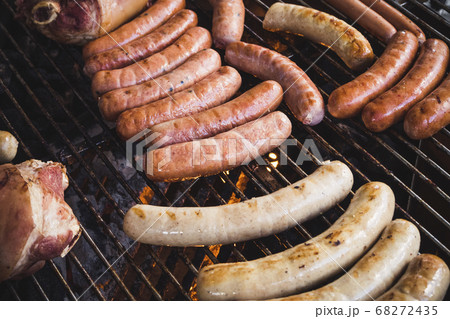 Sausages on BBQ Grill fire Outdoor party Camping lifestyle Sausages on BBQ Grill fire Outdoor party Camping lifestyle 68272435