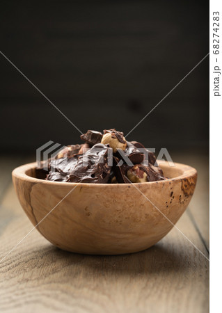 homemade dark chocolate with hazelnuts in wood bowl homemade dark chocolate with hazelnuts in wood bowl 68274283