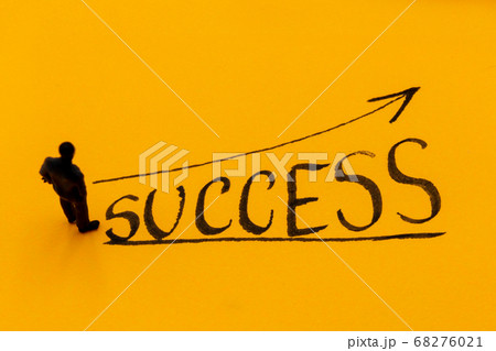 Miniature figurine posed as businessman in front 68276021