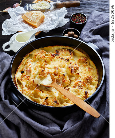 Cauliflower cheese casserole on a black dish Cauliflower cheese casserole on a black dish 68280096