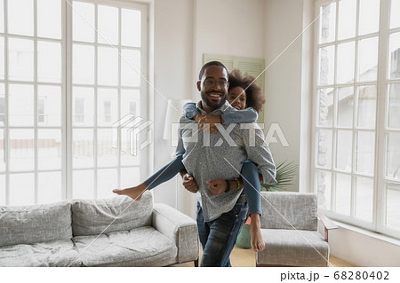 Happy biracial father and little daughter play at home Happy biracial father and little daughter play at home 68280402